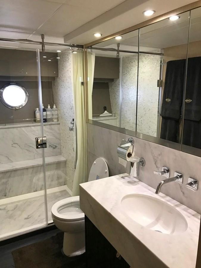 a bathroom with a glass shower door aboard MOJO RISIN Yacht for Sale