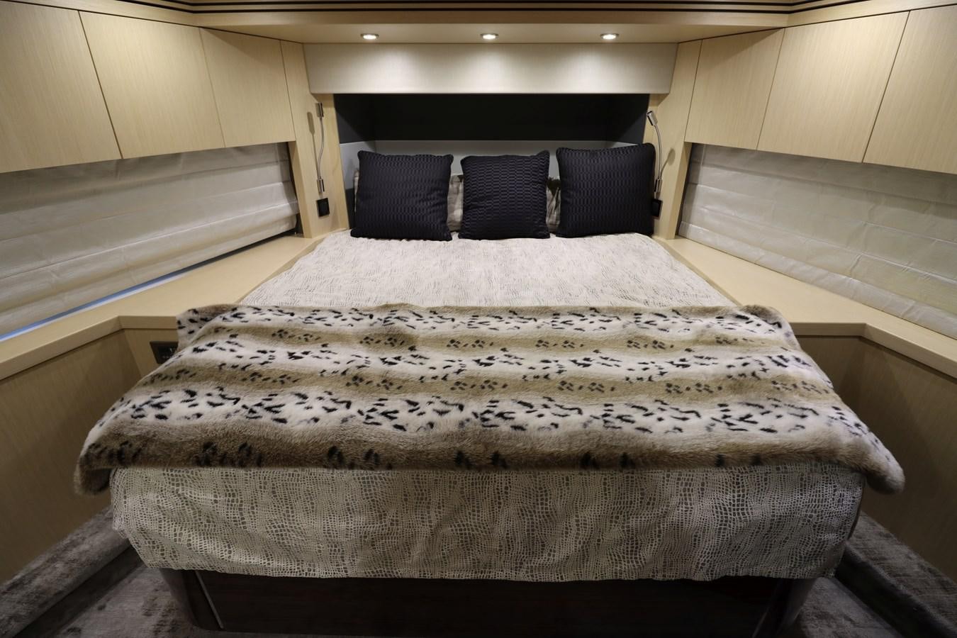 a bed with a white sheet aboard MOJO RISIN Yacht for Sale