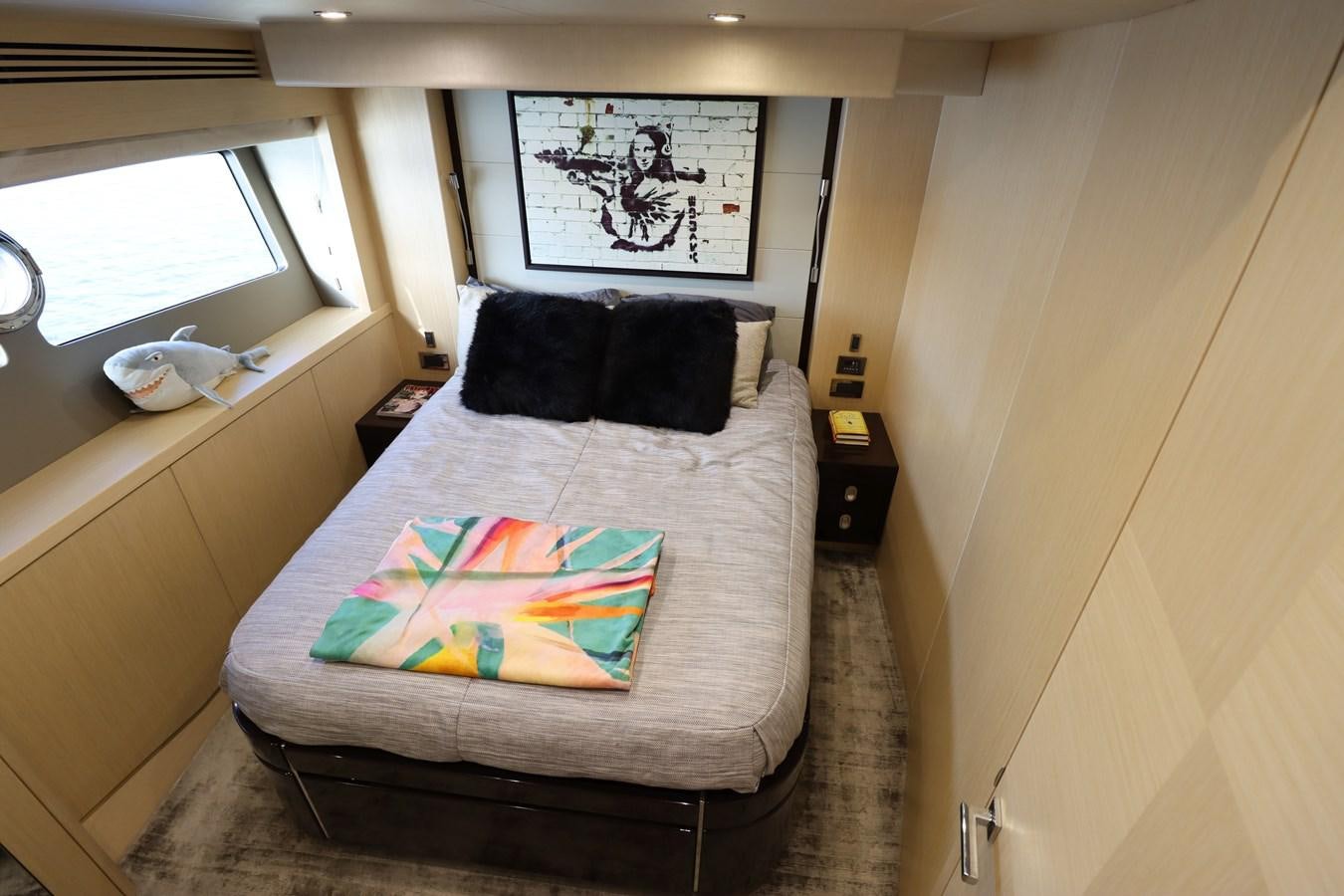 a bed with a colorful blanket aboard MOJO RISIN Yacht for Sale