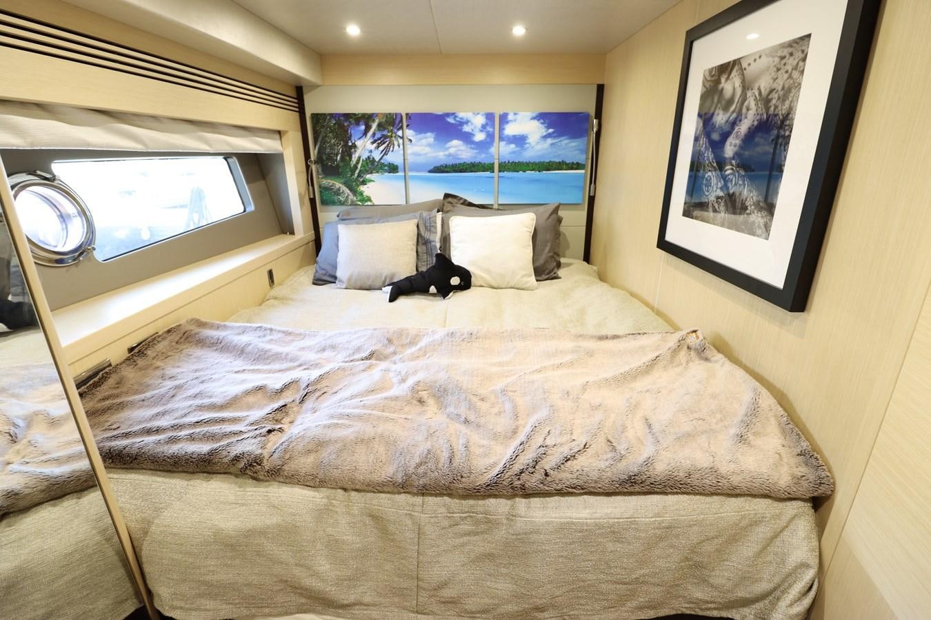 a cat lying on a bed aboard MOJO RISIN Yacht for Sale
