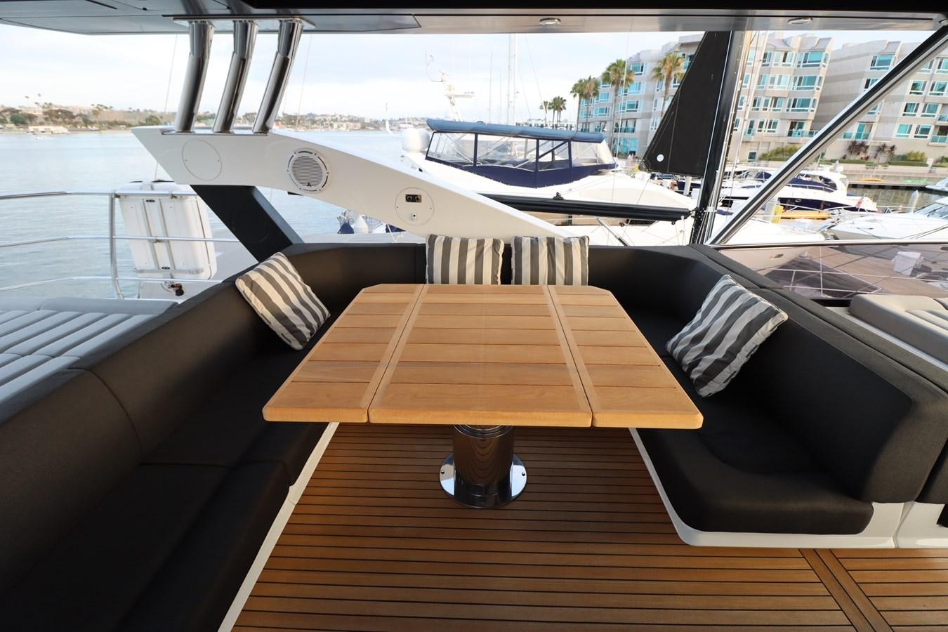 a wooden table on a boat aboard MOJO RISIN Yacht for Sale