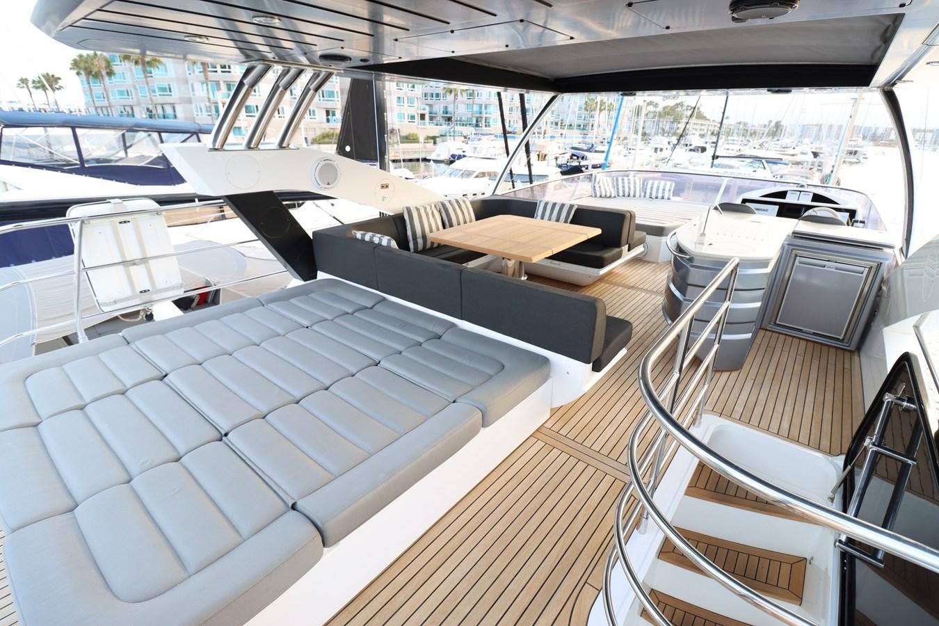 a room with a deck and a view of the water aboard MOJO RISIN Yacht for Sale