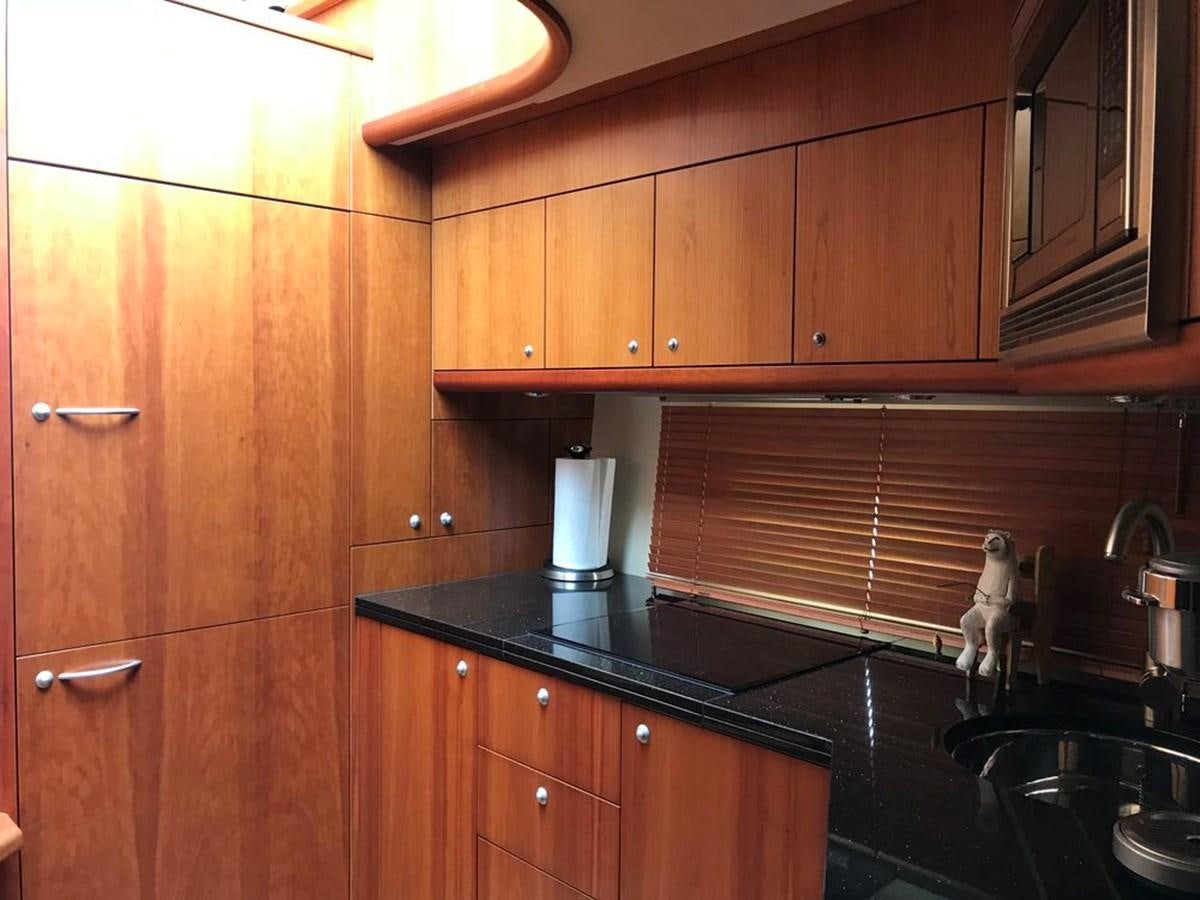 a kitchen with wooden cabinets aboard DAY DREAMER Yacht for Sale