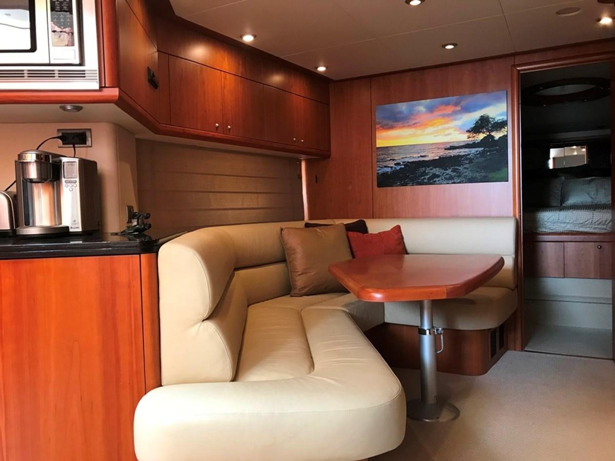 a living room with a couch and a table aboard DAY DREAMER Yacht for Sale