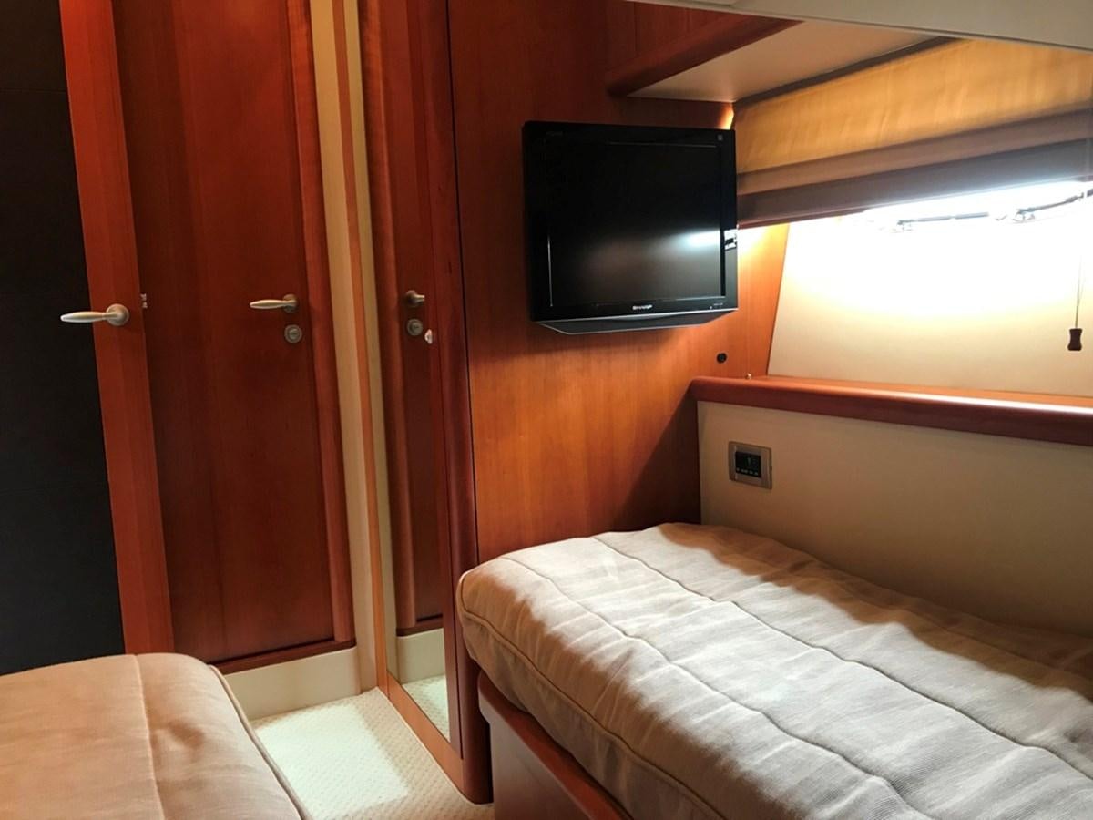 a room with a tv and a bed aboard DAY DREAMER Yacht for Sale