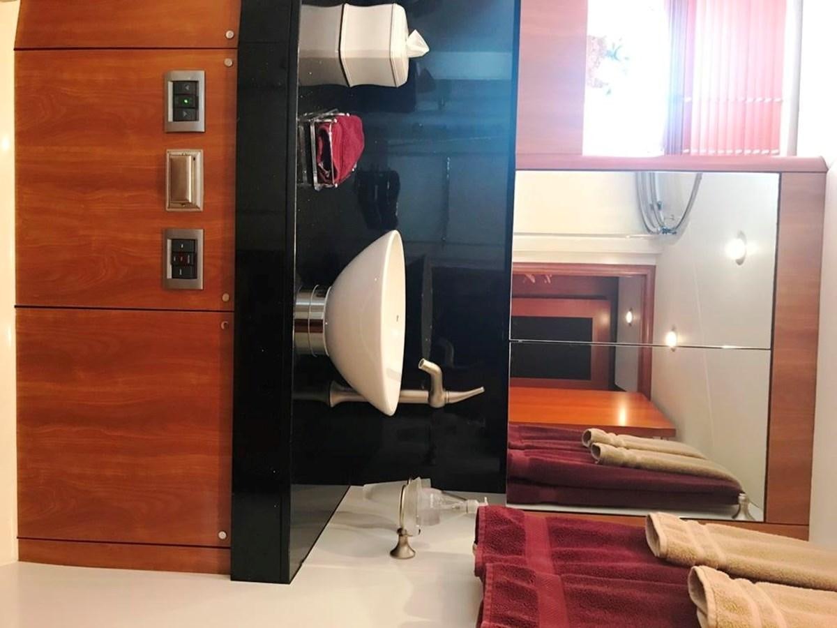 a bathroom with a toilet and a sink aboard DAY DREAMER Yacht for Sale