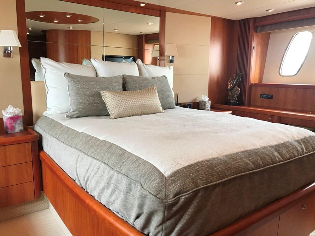 a bed with a white comforter aboard DAY DREAMER Yacht for Sale
