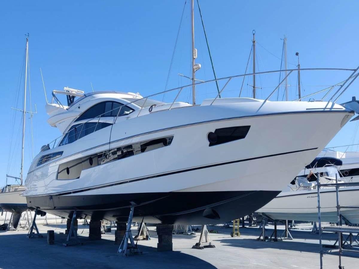 a white yacht on a dock aboard LONG WAY ROUND Yacht for Sale