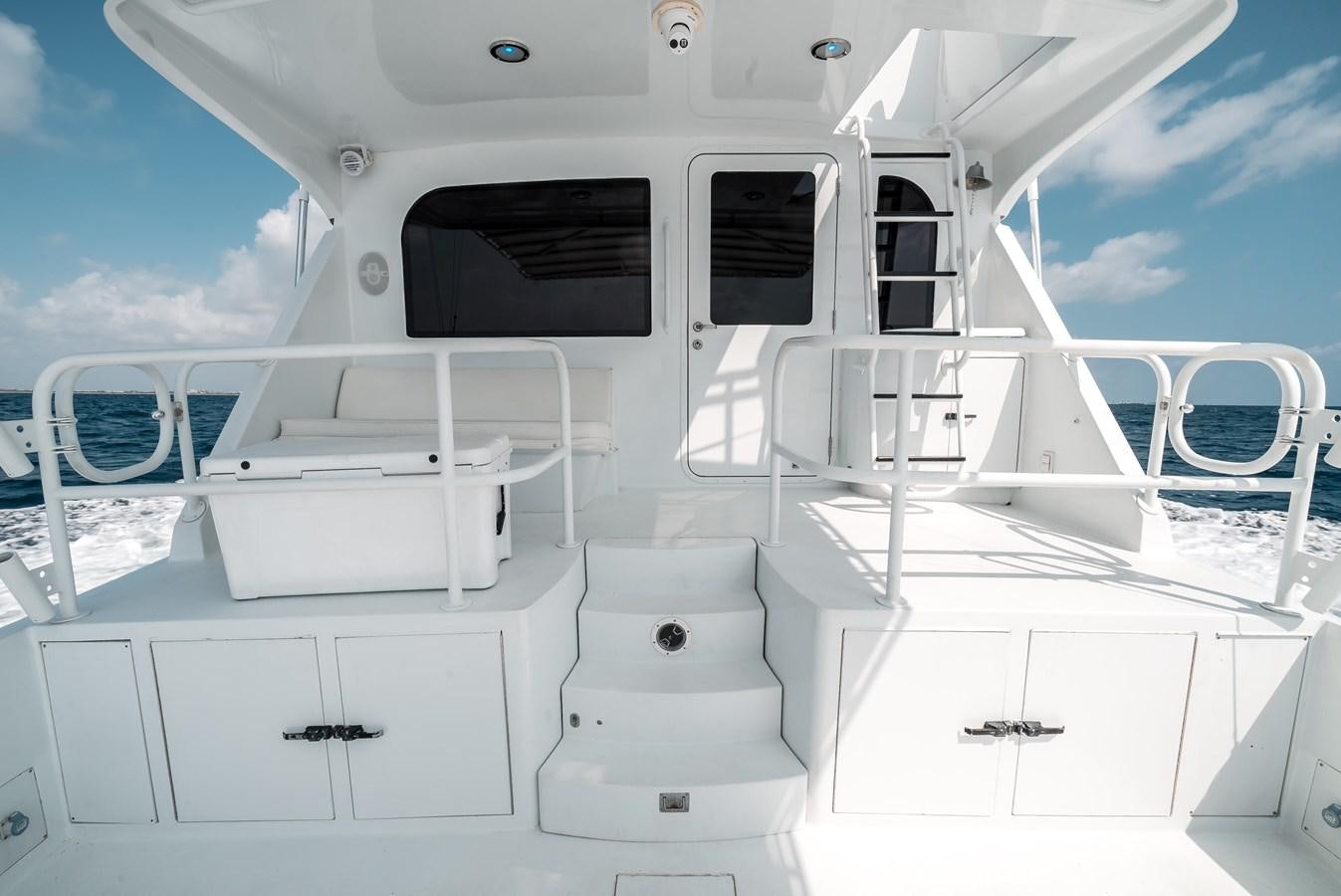 a white boat with a deck aboard JUST LIKE THAT Yacht for Sale