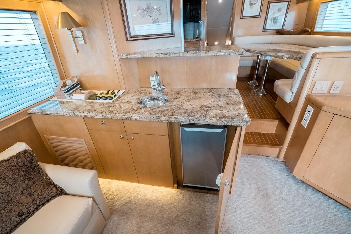 a kitchen with a counter and chairs aboard JUST LIKE THAT Yacht for Sale