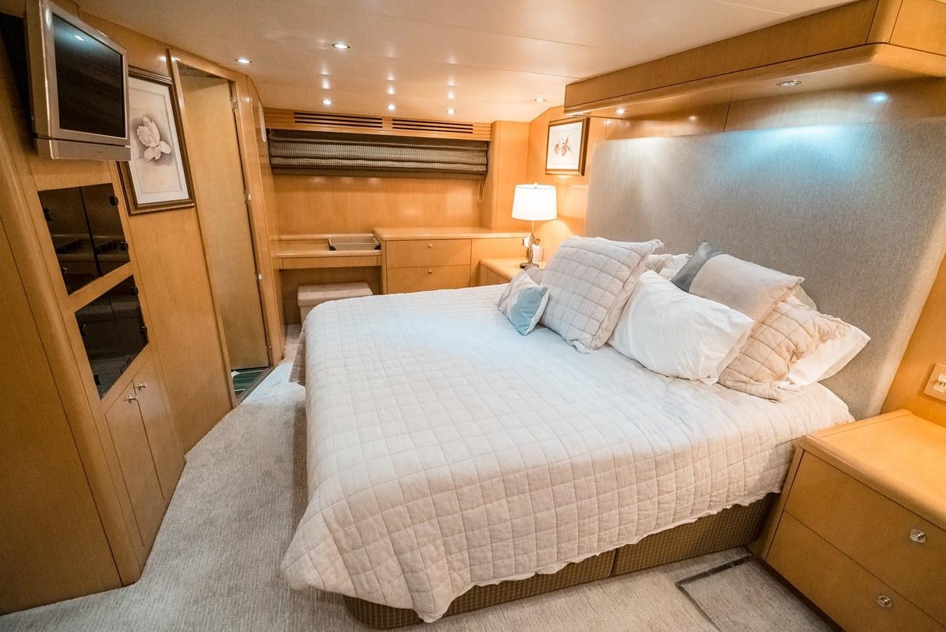a bedroom with a bed and a television aboard JUST LIKE THAT Yacht for Sale