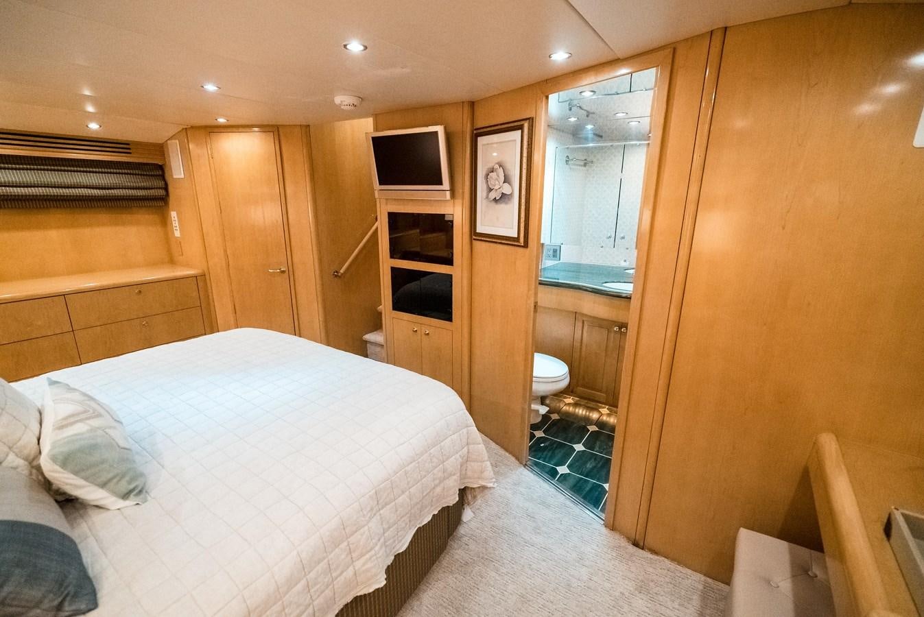 a bedroom with a bed and a mirror aboard JUST LIKE THAT Yacht for Sale