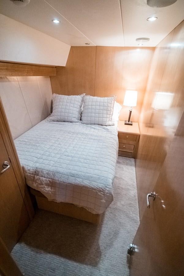 a bed with a blue and white comforter and pillows aboard JUST LIKE THAT Yacht for Sale