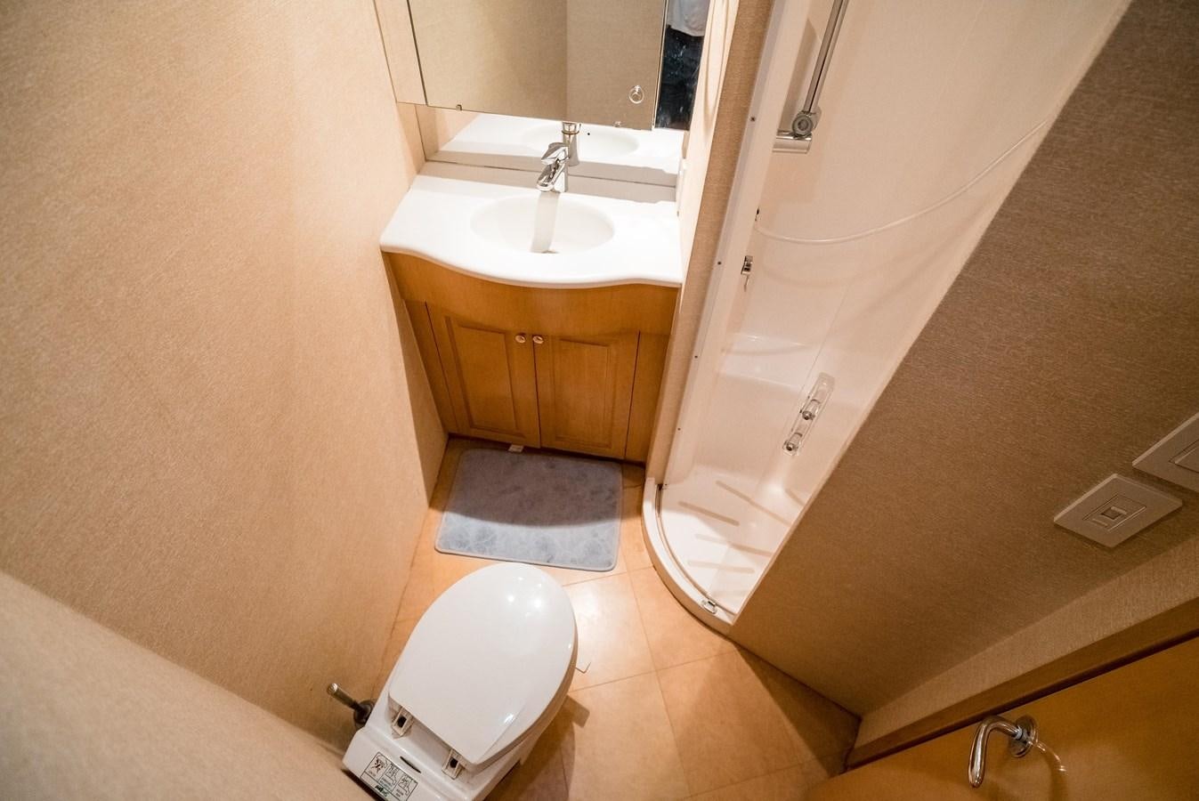 a bathroom with a tub sink and toilet aboard JUST LIKE THAT Yacht for Sale