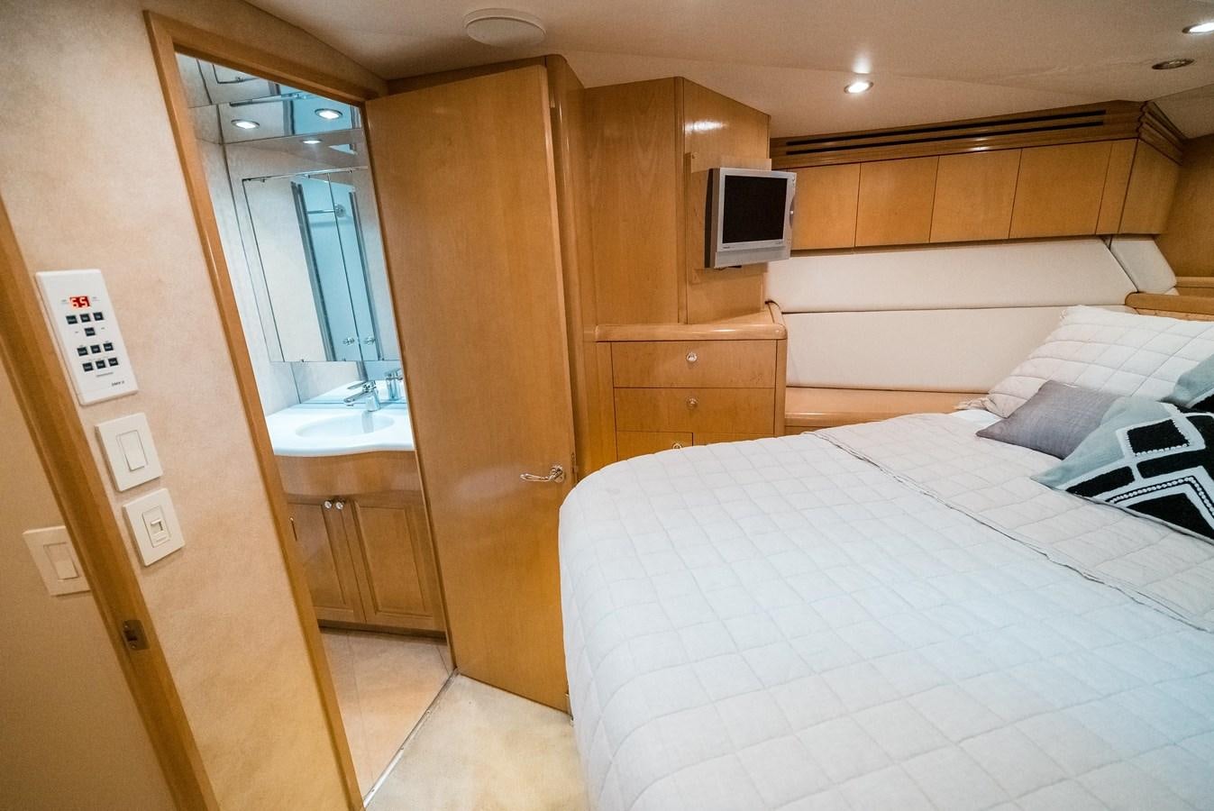 a room with a bed and a television aboard JUST LIKE THAT Yacht for Sale