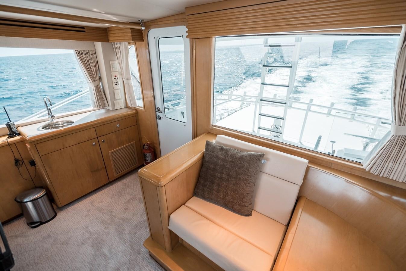 a living room with a couch and a window aboard JUST LIKE THAT Yacht for Sale