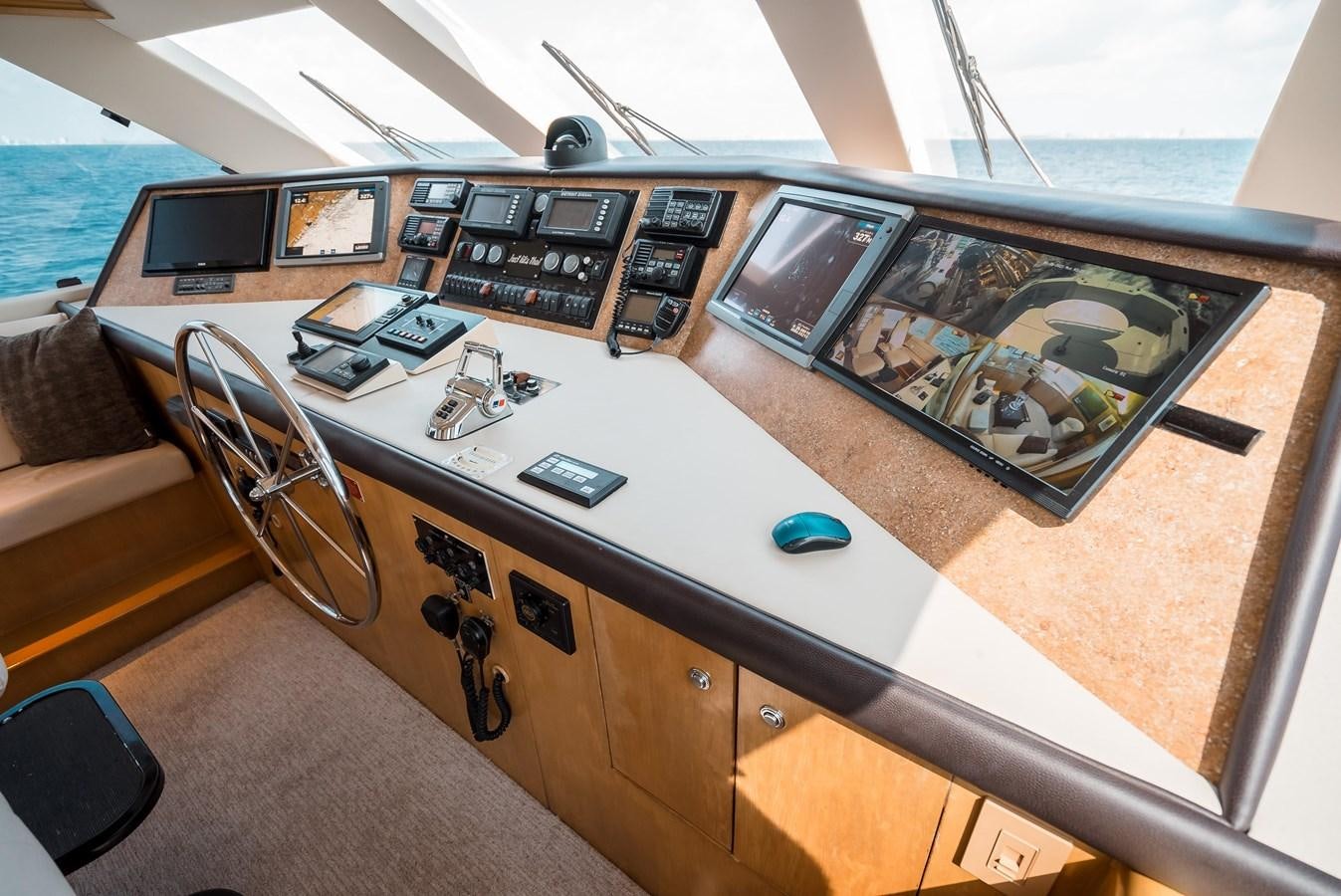 a table with a computer and electronics on it aboard JUST LIKE THAT Yacht for Sale