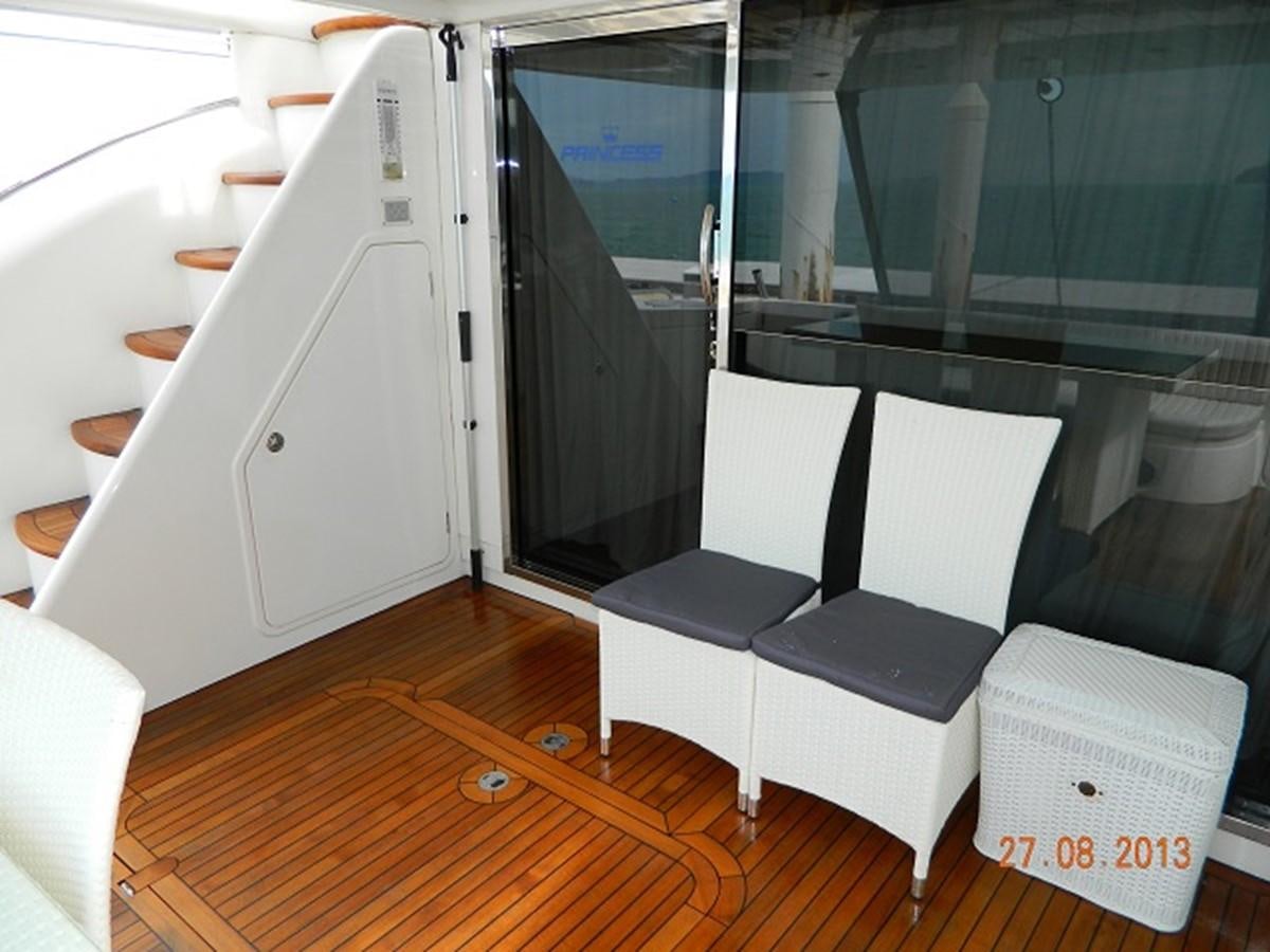 a room with a table and chairs aboard LOUISE Yacht for Sale