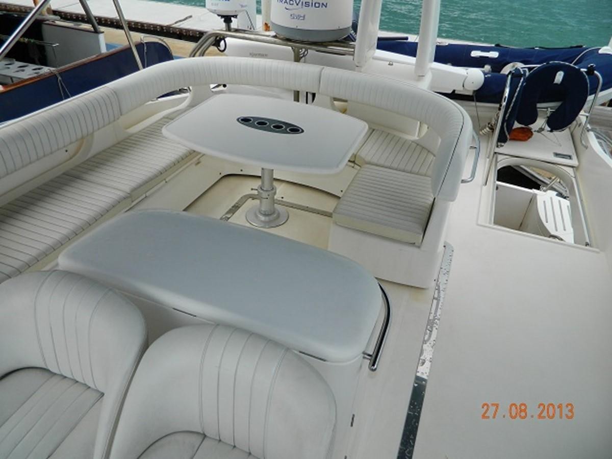 a white boat with a steering wheel aboard LOUISE Yacht for Sale