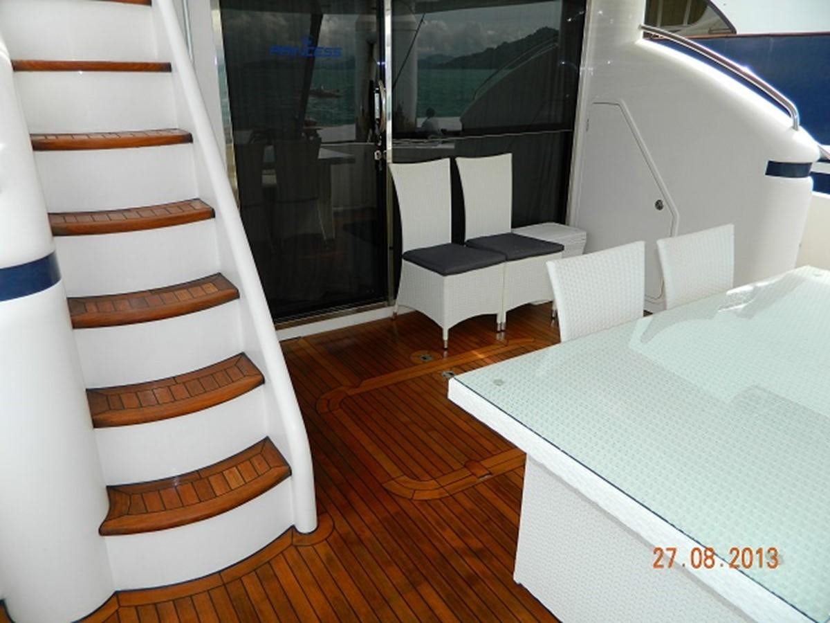 a room with a bed and a table aboard LOUISE Yacht for Sale