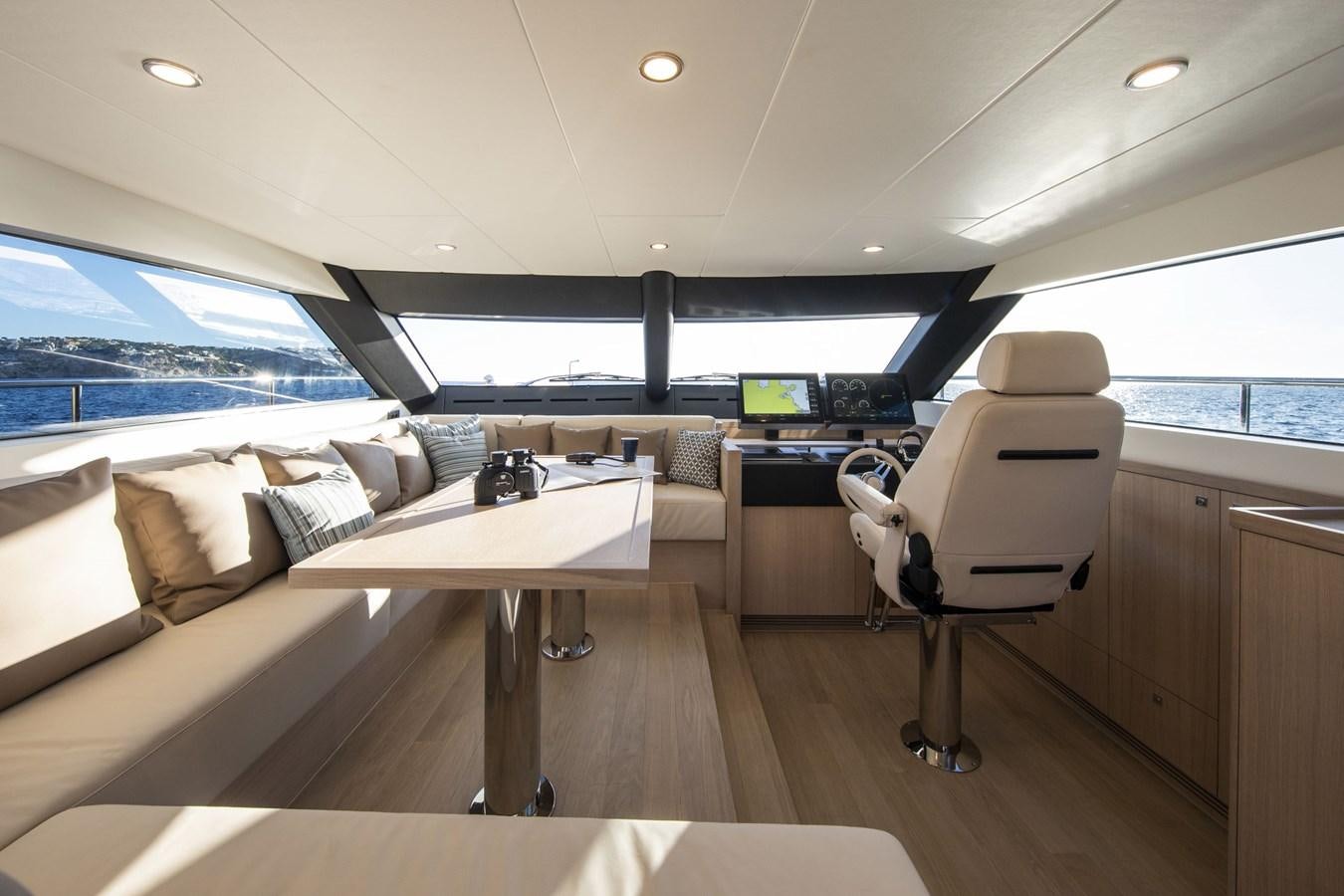 a room with a couch and a table and chairs aboard VAN DER VALK BEACHCLUB 660 FLYBRIDGE Yacht for Sale