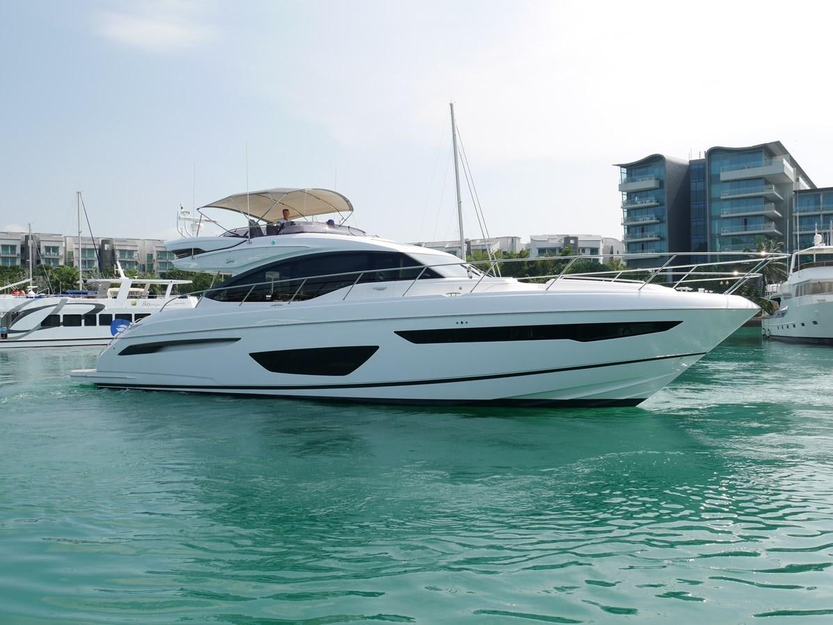 a white yacht in a harbor aboard KATI Yacht for Sale