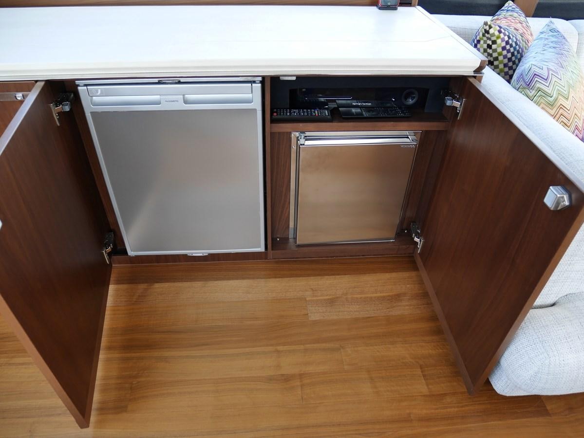 a kitchen with wooden cabinets aboard KATI Yacht for Sale