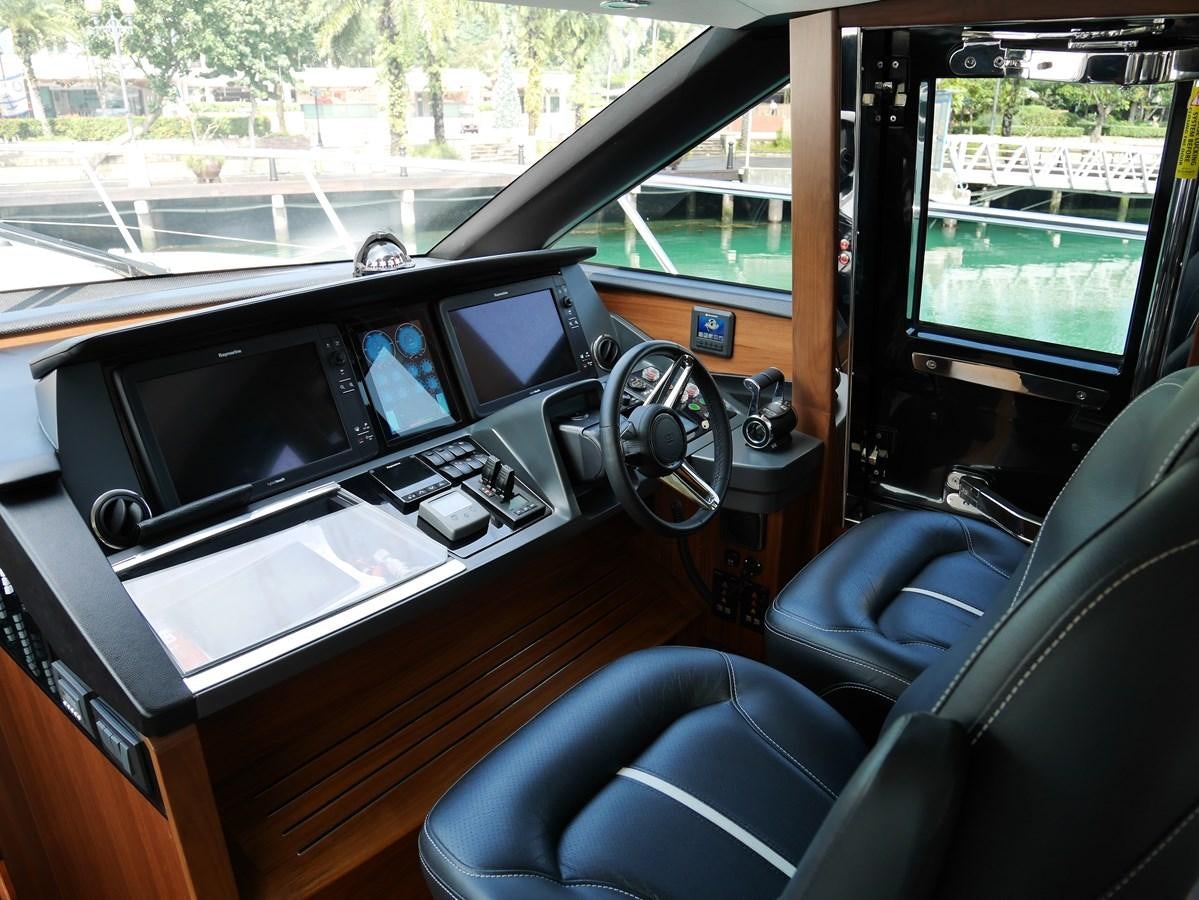 inside of a vehicle with a large screen and a steering wheel aboard KATI Yacht for Sale