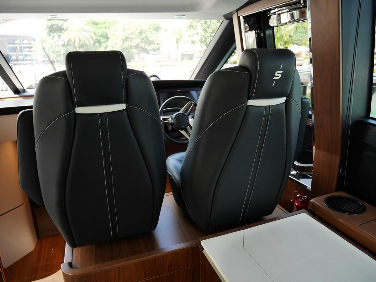 a group of chairs in a vehicle aboard KATI Yacht for Sale