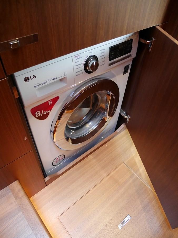 a washing machine in a room aboard KATI Yacht for Sale