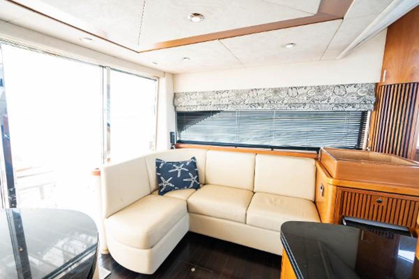 a living room with a couch and a window aboard SOLE MIO Yacht for Sale