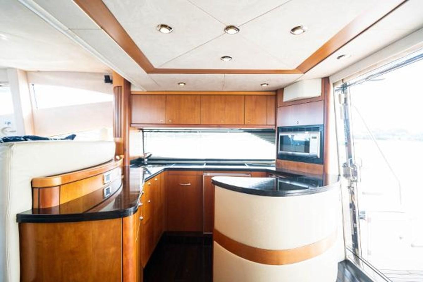 a kitchen with wooden cabinets aboard SOLE MIO Yacht for Sale