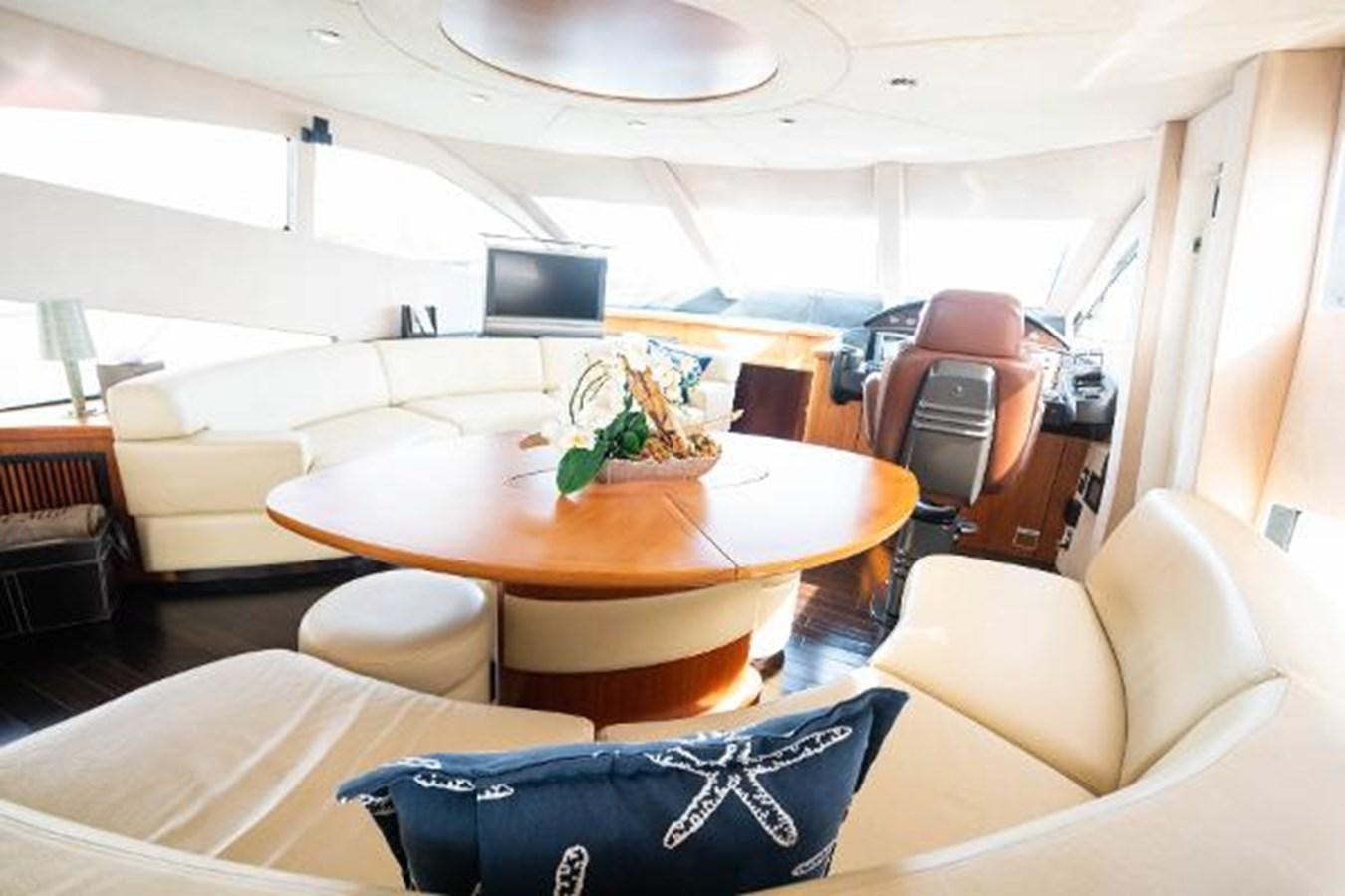 a room with a table and chairs aboard SOLE MIO Yacht for Sale
