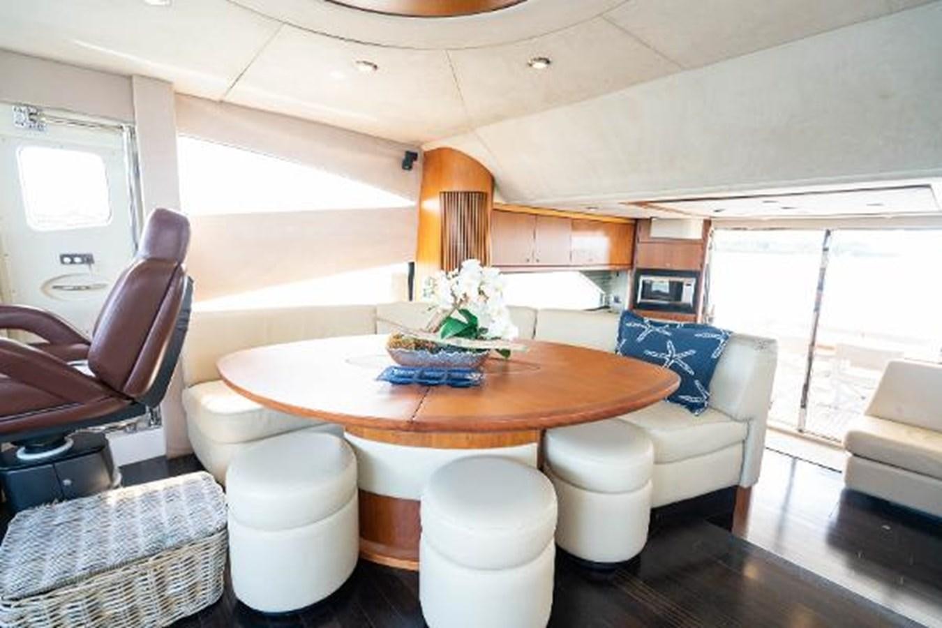a dining table with chairs and a plant on it aboard SOLE MIO Yacht for Sale