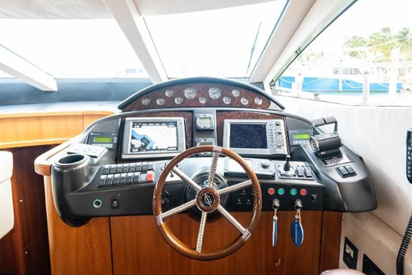 a steering wheel and dashboard of a car aboard SOLE MIO Yacht for Sale