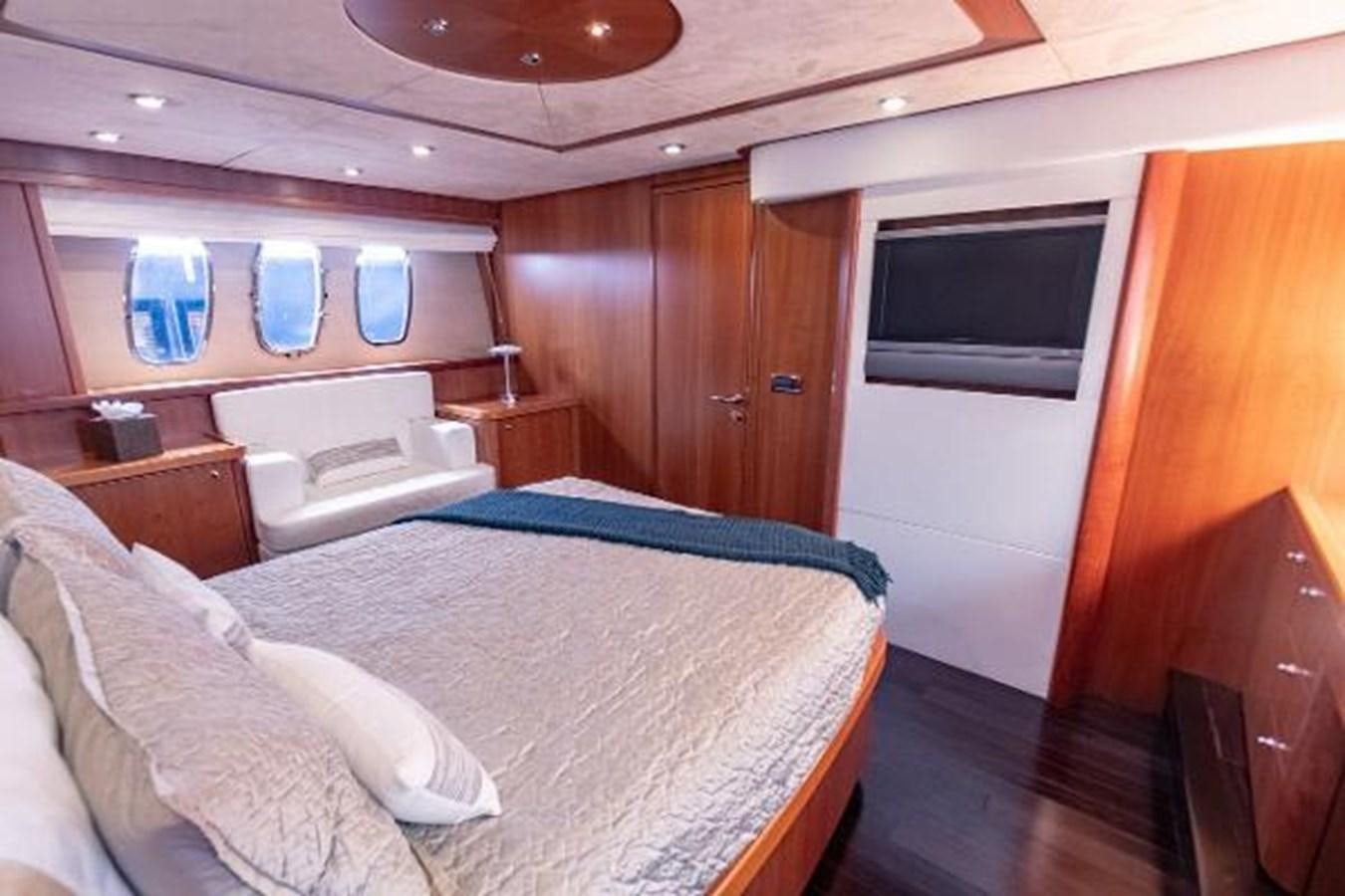 a room with a bed and a television aboard SOLE MIO Yacht for Sale