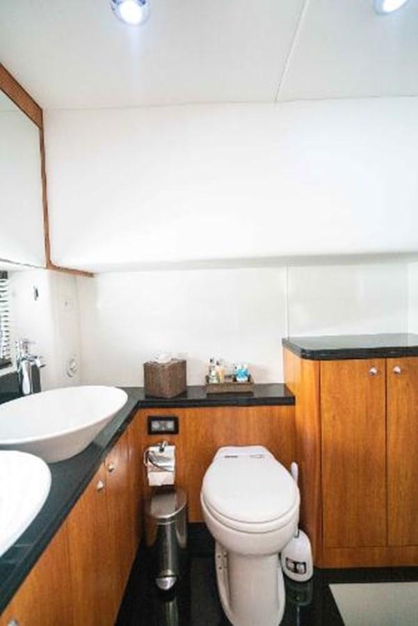 a bathroom with a toilet sink and a mirror aboard SOLE MIO Yacht for Sale