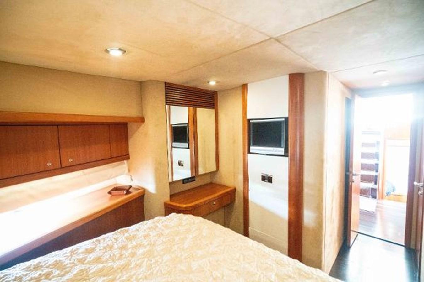 a bedroom with a bed and a television aboard SOLE MIO Yacht for Sale