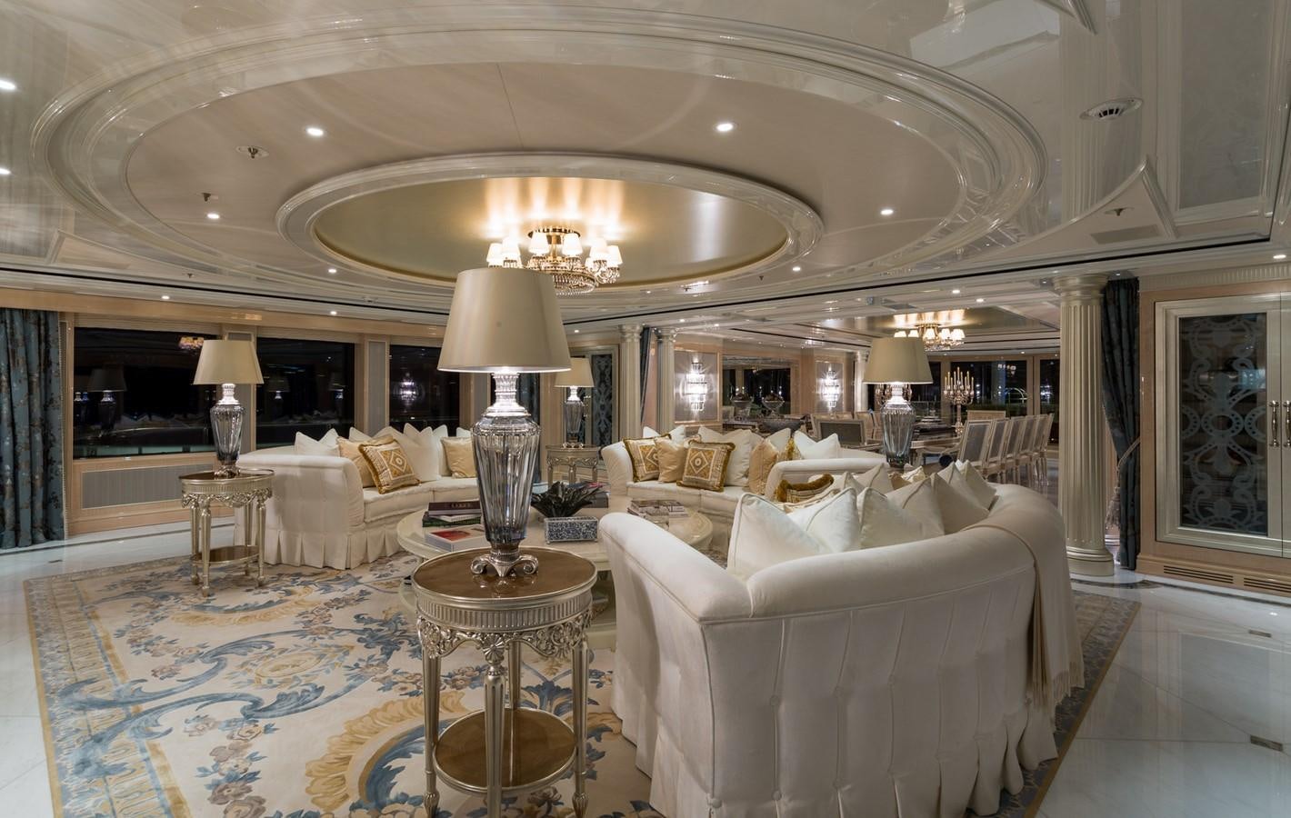 a large living room with a chandelier aboard PLVS VLTRA Yacht for Sale