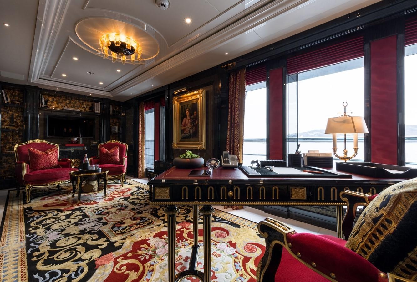 a large living room with a piano aboard PLVS VLTRA Yacht for Sale