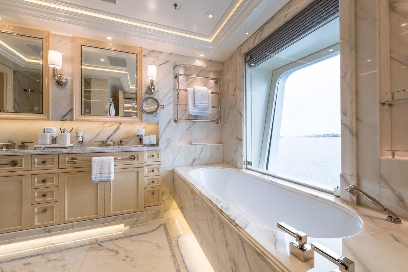 a bathroom with a tub sink and a window aboard PLVS VLTRA Yacht for Sale