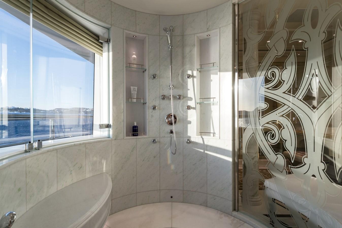 a bathroom with a shower and bathtub aboard PLVS VLTRA Yacht for Sale