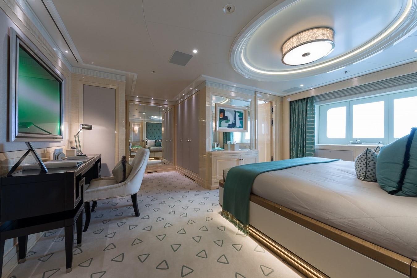 a room with a bed and a desk aboard PLVS VLTRA Yacht for Sale