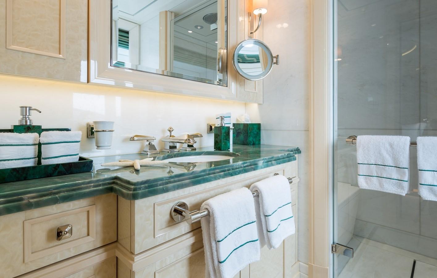 a bathroom with a sink and towels aboard PLVS VLTRA Yacht for Sale