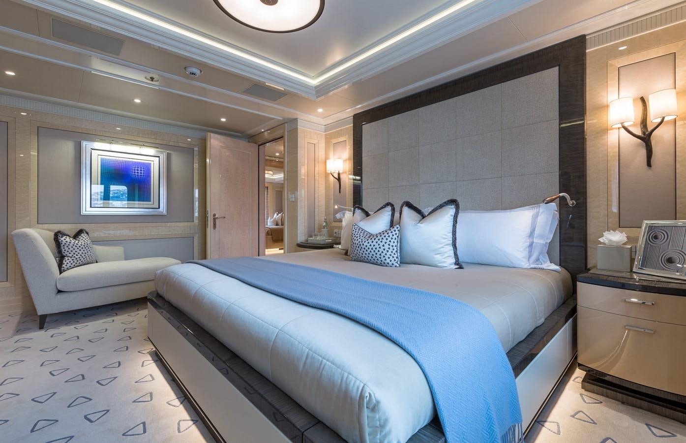 a large bedroom with a bed aboard PLVS VLTRA Yacht for Sale