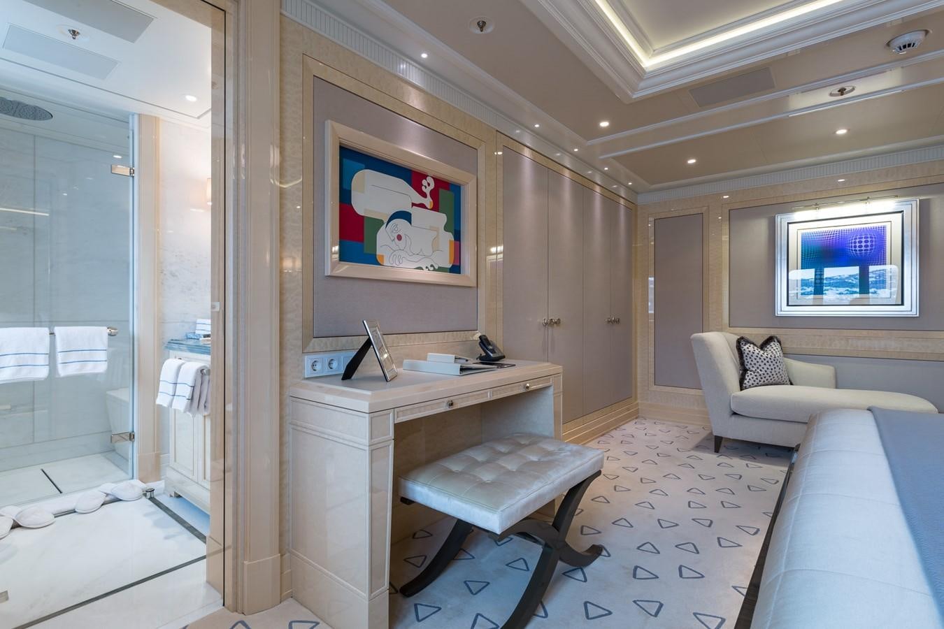a room with a couch and a table aboard PLVS VLTRA Yacht for Sale