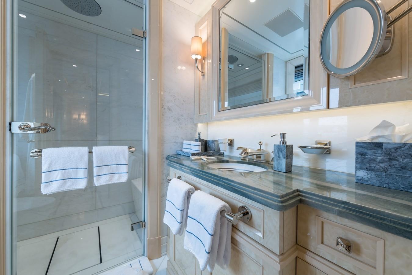 a bathroom with a glass shower aboard PLVS VLTRA Yacht for Sale