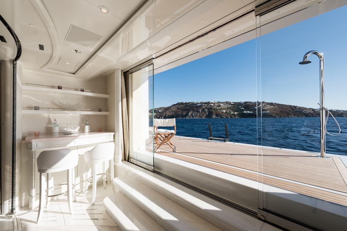 a room with a view of the water and the land below aboard PLVS VLTRA Yacht for Sale