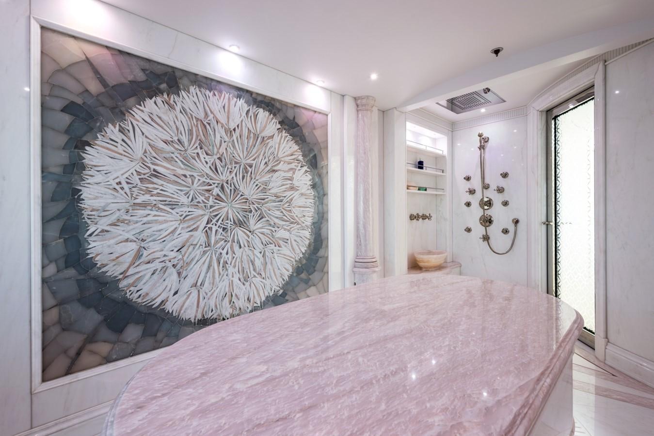 a large pink tablecloth in a room with a large mirror aboard PLVS VLTRA Yacht for Sale