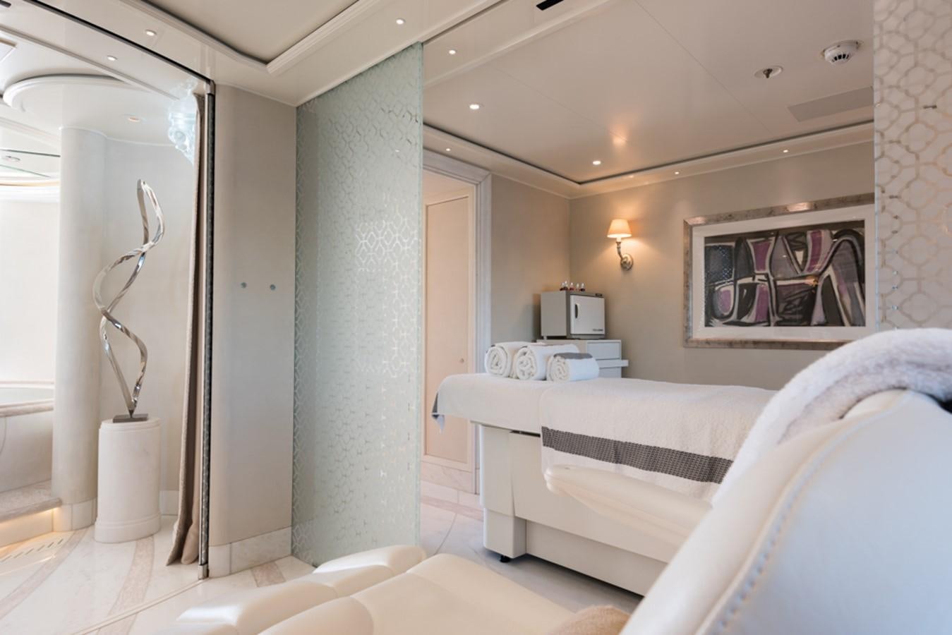 a room with a bed and a mirror aboard PLVS VLTRA Yacht for Sale